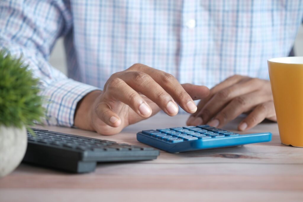 a person using a calculator on a table